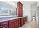 A bathroom with granite countertops, dark wood cabinets, and dual sinks at 301 Kinsale Dr, Chapel Hill, NC 27517