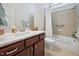 Bathroom with vanity, tile floors, shower with tub and curtain and natural light at 301 Kinsale Dr, Chapel Hill, NC 27517