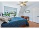 Comfortable bedroom featuring plants in front of a window and a dark bed at 301 Kinsale Dr, Chapel Hill, NC 27517
