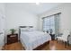 Well-lit bedroom featuring hardwood floors, a queen-size bed, and floral curtains at 301 Kinsale Dr, Chapel Hill, NC 27517