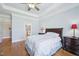 Bright bedroom with hardwood floors, a tray ceiling, and an ensuite bathroom with a jacuzzi at 301 Kinsale Dr, Chapel Hill, NC 27517