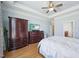 This bright bedroom includes a spacious dresser, a flat screen TV, hardwood floors, and ensuite bathroom at 301 Kinsale Dr, Chapel Hill, NC 27517