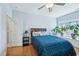 Comfortable bedroom featuring a cozy blue bed, wooden floor and a window at 301 Kinsale Dr, Chapel Hill, NC 27517