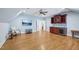 Spacious bonus room features a wet bar, wood floors, ceiling fan, and large tv screen at 301 Kinsale Dr, Chapel Hill, NC 27517