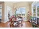 Sunlit breakfast nook with vaulted ceiling, backyard view and wood floors at 301 Kinsale Dr, Chapel Hill, NC 27517