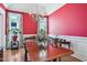 Elegant dining room with a chandelier, hardwood floors, and large windows at 301 Kinsale Dr, Chapel Hill, NC 27517