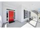Inviting covered front porch with seating area and a vibrant red front door at 301 Kinsale Dr, Chapel Hill, NC 27517