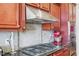 Detailed kitchen photo featuring stainless hood and cherry cabinets with granite countertop at 301 Kinsale Dr, Chapel Hill, NC 27517