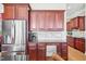 Kitchen cabinets and counters with stainless steel fridge, coffee maker, and modern tiling at 301 Kinsale Dr, Chapel Hill, NC 27517