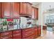 Wet bar features granite countertops and cherry cabinets with mirrored backsplash at 301 Kinsale Dr, Chapel Hill, NC 27517