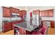 Gourmet kitchen with stainless appliances, granite countertops, and cherry wood cabinets at 301 Kinsale Dr, Chapel Hill, NC 27517