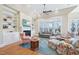 Bright living room with a fireplace, built-in bookshelves, and large windows at 301 Kinsale Dr, Chapel Hill, NC 27517