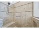 Walk-in shower featuring neutral tile, a built-in bench, and a rainfall shower head at 301 Kinsale Dr, Chapel Hill, NC 27517