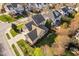 Overhead view of a brick home with a well-maintained yard, patio, and surrounding neighborhood at 321 Weycroft Grant Dr, Cary, NC 27519