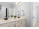 Well-lit bathroom features a double sink vanity with white countertop and vanity lighting at 321 Weycroft Grant Dr, Cary, NC 27519