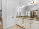 Bathroom features a dual sink vanity with granite countertop and framed mirror at 321 Weycroft Grant Dr, Cary, NC 27519