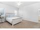 Bright bedroom with a light wood bed frame, blue accents, and neutral carpeting at 321 Weycroft Grant Dr, Cary, NC 27519