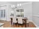 Bright dining area featuring hardwood floors, a wooden table with upholstered chairs, and natural light at 321 Weycroft Grant Dr, Cary, NC 27519