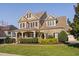 A charming two-story brick home with a welcoming front porch and well-manicured landscaping at 321 Weycroft Grant Dr, Cary, NC 27519
