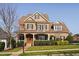 Elegant brick home featuring a welcoming front porch, manicured landscaping, and a classic design at 321 Weycroft Grant Dr, Cary, NC 27519