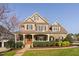 Stunning brick home with a welcoming front porch, manicured landscaping, and classic architectural details at 321 Weycroft Grant Dr, Cary, NC 27519