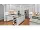 Stylish kitchen with white cabinets, granite counters, large island, and stainless steel appliances at 321 Weycroft Grant Dr, Cary, NC 27519