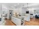 Open kitchen boasts stainless appliances, granite counters, and island with seating, flowing into a bright living area at 321 Weycroft Grant Dr, Cary, NC 27519