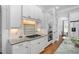 Well-appointed kitchen with granite counters, white cabinets, stainless appliances, and convenient gas cooktop at 321 Weycroft Grant Dr, Cary, NC 27519