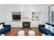 Cozy living room with brick fireplace and built-in shelving, bathed in natural light at 321 Weycroft Grant Dr, Cary, NC 27519