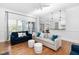 Open-concept living room featuring hardwood floors and seamless flow into the dining area at 321 Weycroft Grant Dr, Cary, NC 27519