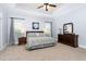 Spacious main bedroom with tray ceiling, plush carpet, and abundant natural light at 321 Weycroft Grant Dr, Cary, NC 27519
