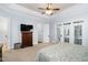 Bright main bedroom with large windows, ceiling fan, and cozy carpet flooring at 321 Weycroft Grant Dr, Cary, NC 27519