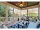 Inviting screened porch with wood flooring and ceiling, offering a relaxing outdoor space at 321 Weycroft Grant Dr, Cary, NC 27519