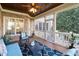 Charming screened porch with comfortable seating, brick accents, and outdoor views at 321 Weycroft Grant Dr, Cary, NC 27519