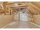 Unfinished attic space with exposed beams and insulation, offering potential for storage or expansion at 34 Triton Ct, Clayton, NC 27520