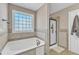 Beautiful bathroom features a large soaking tub and separate shower with glass doors at 34 Triton Ct, Clayton, NC 27520