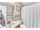 Bathroom featuring a single sink vanity, toilet, and shower with a white curtain at 34 Triton Ct, Clayton, NC 27520