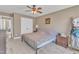 Bedroom featuring a neutral color scheme and ceiling fan, with closet and access to an office area at 34 Triton Ct, Clayton, NC 27520