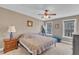 Cozy bedroom with a ceiling fan, bedside tables, and natural light from the large windows at 34 Triton Ct, Clayton, NC 27520