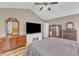 Comfortable bedroom boasts natural light, ceiling fan, and hardwood floors at 34 Triton Ct, Clayton, NC 27520
