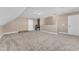 Spacious carpeted bonus room with ample natural light and neutral wall colors at 34 Triton Ct, Clayton, NC 27520