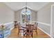 Bright dining room featuring a wooden table and large windows, perfect for Gathering meals at 34 Triton Ct, Clayton, NC 27520