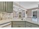 Kitchen featuring granite countertops, green cabinets, stainless appliances, and a breakfast nook at 34 Triton Ct, Clayton, NC 27520