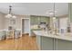 Charming kitchen featuring green cabinets, granite countertops, and stainless steel appliances at 34 Triton Ct, Clayton, NC 27520