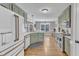 Bright kitchen with green cabinets, stainless appliances, granite countertops, and hardwood floors at 34 Triton Ct, Clayton, NC 27520