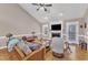 Cozy living room with a fireplace, hardwood floors, and a comfortable seating arrangement with a vaulted ceiling at 34 Triton Ct, Clayton, NC 27520