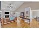 Open-concept living room with hardwood floors, a fireplace, and neutral paint colors, perfect for entertaining at 34 Triton Ct, Clayton, NC 27520