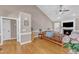 Comfortable living room showcasing hardwood floors, a vaulted ceiling, and cozy furnishings with neutral color palette at 34 Triton Ct, Clayton, NC 27520