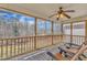 Enjoy the view on this screened porch with wood floors, comfortable seating and a ceiling fan at 34 Triton Ct, Clayton, NC 27520