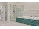 Bathroom featuring a walk-in shower, tub, and white and blue tile detail at 405 Silver Creek Trl, Chapel Hill, NC 27514